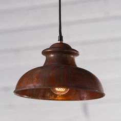 an old fashioned light hanging from a ceiling