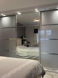 a bedroom with mirrored closet doors and a bed