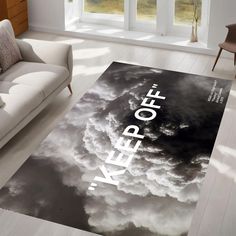 a living room area rug with the words keep off on it and clouds in the sky