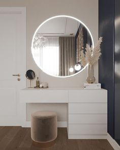 a white vanity with a round mirror above it and a stool in front of it