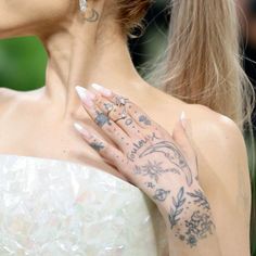 a woman with tattoos on her arm and hand