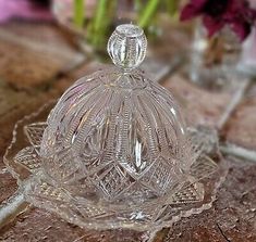 a clear glass dish sitting on top of a wooden table