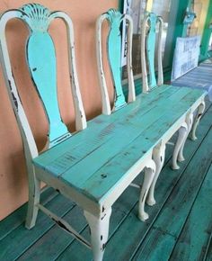 four chairs sitting on top of a wooden floor next to each other in front of a wall