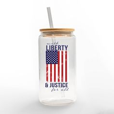 a glass jar with a straw in it and the words liberty 6 justice on it