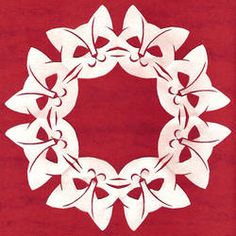 a white paper wreath on a red background