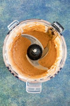 an overhead view of a food processor filled with sauce