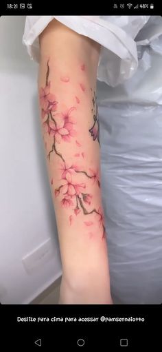 a woman's arm with pink flowers on it