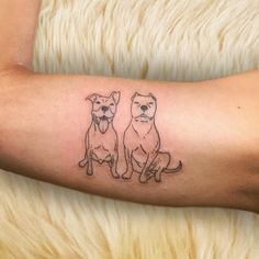 two dogs tattoo on the right arm and left arm, with one dog sitting next to another