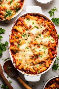 a casserole dish filled with pasta and parmesan cheese, garnished with parsley