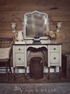 an antique vanity with mirror and vases on it