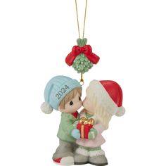 a christmas ornament with a boy giving a girl a present