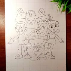 a drawing of some cartoon characters on a piece of paper next to a potted plant