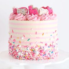 a birthday cake with sprinkles and pink frosting