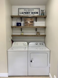 a washer and dryer in a laundry room with shelving above the washer