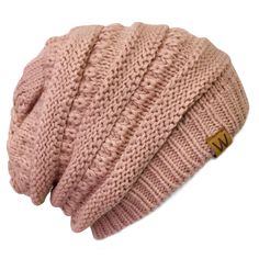 a pink knitted beanie with a wooden tag on the front and side of it