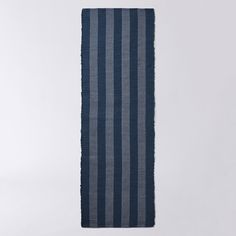 a blue and white striped towel hanging on a wall