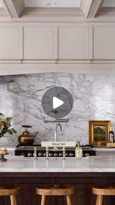 a kitchen with marble counter tops and wooden stools