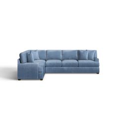 a blue sectional couch sitting on top of a white floor