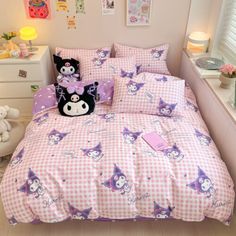 a bed with pink and white checkered bedspread, pillows and stuffed animals