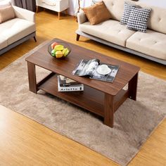 a living room with two couches, a coffee table and a rug on the floor