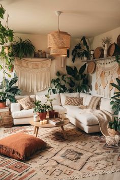 a living room with lots of plants on the wall and rugs hanging from the ceiling