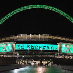 the stadium is lit up with green lights