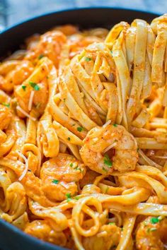 pasta with shrimp and parmesan cheese in a skillet