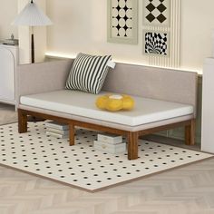 a living room with white furniture and black and white decor