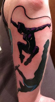 a man with a tattoo on his arm has a drawing of a person doing a trick