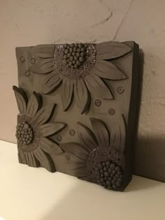 this is a ceramic block with flowers on it