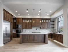 a large kitchen with wooden cabinets and stainless steel appliances