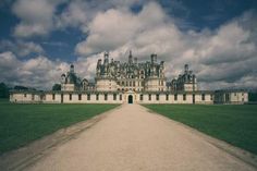 a large building with a long driveway leading to it