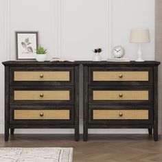 two black and gold dressers sitting next to each other on top of a hard wood floor