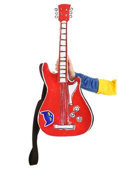 a person holding up a red guitar shaped like a hand with an eye patch on it