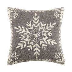 a gray and white pillow with snowflakes on it