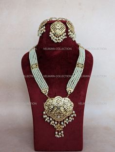 Beautiful Punjabi Jadau pippal patti long necklace set with earrings and tikka.  Earring Length - 3-3.5 inch approx Width - 1.5 inch approx  Necklace Length - 13.5 inch approx. Adjustable length with sliding clasp and dori. Made with jadau faux pearls and gold plated. Feel free to contact us if you have any questions.  Why buy from us? Guaranteed good quality. Actual product shown in the video. You get what you see. Please note color may vary slightly due to digital image limitations and the variation in electronic devices. Read shop policies before placing order. All sales are final. Thank you Thank you and happy shopping :) Jadau Necklace, Jadau Jewellery, Jewellery Pearl, Indian Choker Necklace, Sabyasachi Jewellery, American Diamond Necklaces, Necklace Set Indian, Jewellery Indian, Necklace Indian