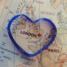 a map with a blue heart shaped pin on it that says london, paris and the british isles