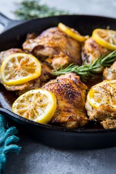 chicken with lemons and rosemary in a cast iron skillet