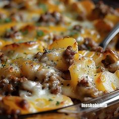 a casserole dish with sausage, cheese and potatoes is shown in a pan