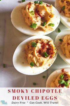 the deviled eggs are stuffed with meat and garnished with green onions