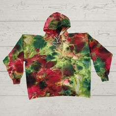 Fall in love with this Tie Dye Hoodie it is perfect for the colder months and for those summer nights on the beach, made from 9.7oz. Ringspun cotton in a  cotton poly blend. Ice Dyed on an incline in abstract shades of red and green.  Hand dyed using procion professional dye for permanent color. Your hoodie will be made to order and won't look exactly like this but have different variations in color as that is the nature of tie dye. I will get it as close to the photo as possible, please be kind Casual Hand Dyed Hoodie For Winter, Tie Dye Hoodie With Drawstring Hood For Winter, Hand Dyed Hooded Sweatshirt For Winter, Fall Hand Dyed Hooded Hoodie, Winter Hand-dyed Hoodie, Hand Dyed Acid Wash Hoodie, Acid Wash Hand Dyed Hoodie, Acid Wash Hand Dyed Hooded Hoodie, Hand-dyed Cotton Hooded Hoodie