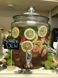 a jar filled with sliced strawberries and lemons