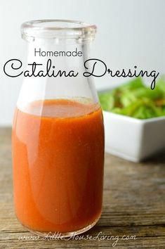 homemade catalina dressing in a glass bottle on a table with lettuce