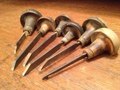 seven old woodworking tools are laying on the table