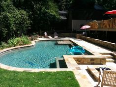 an empty swimming pool in the middle of a yard