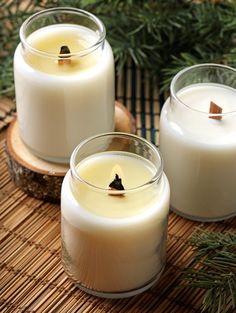 three candles sitting on top of a bamboo mat