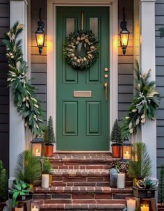 a green front door with wreaths and candles on the steps next to potted plants