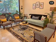 a living room with couches, chairs and rugs in front of large windows