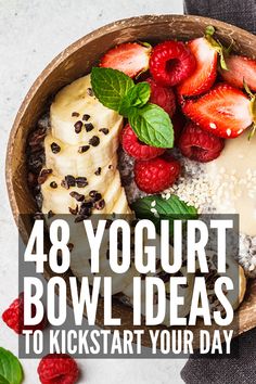 a bowl filled with fruit and yogurt next to raspberries on top