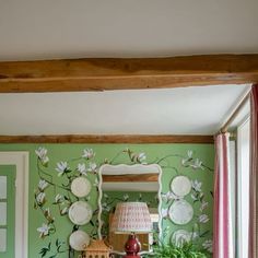 a bedroom with green walls and floral wallpaper